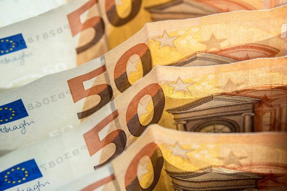 Detailed shot of fifty euro bills highlighting European currency and finance concept.