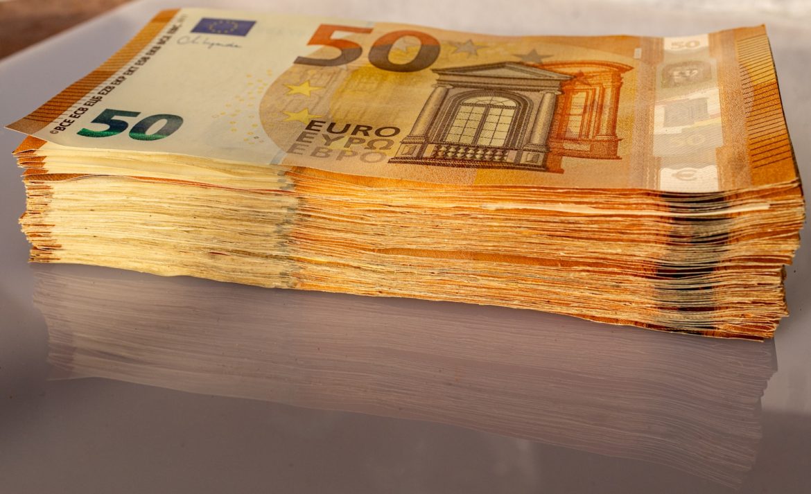 a stack of 50 euro bills sitting on top of a table