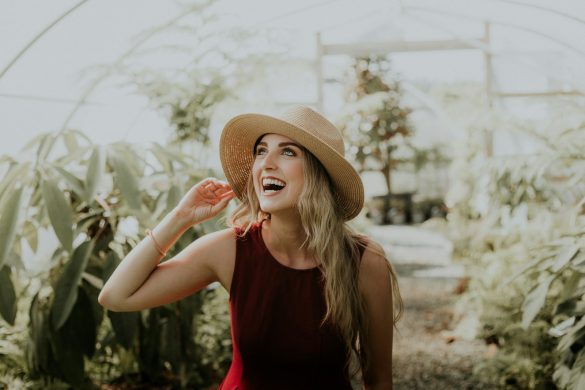 smiling woman wearing red sleeveless dress