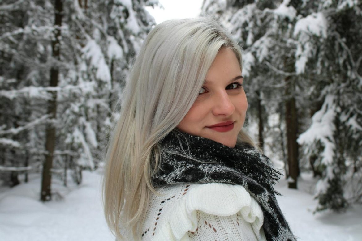 Portrait of a woman in a snowy forest in Saxony, Germany, perfect for winter and travel themes.