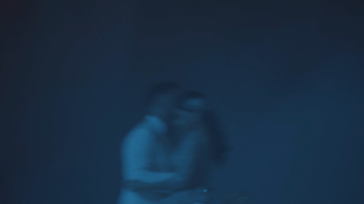 a blurry image of a woman holding a camera
