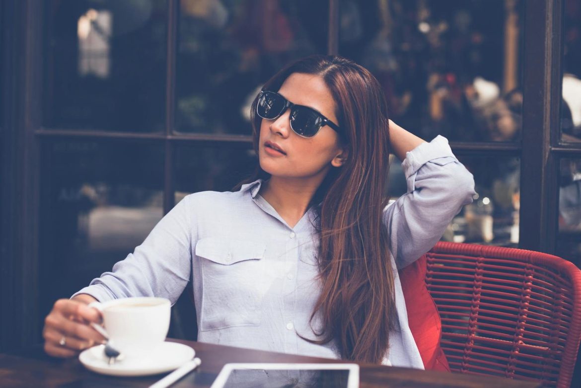 Woman enjoying a relaxed coffee break indoors with a tablet. Perfect for lifestyle and business themes.