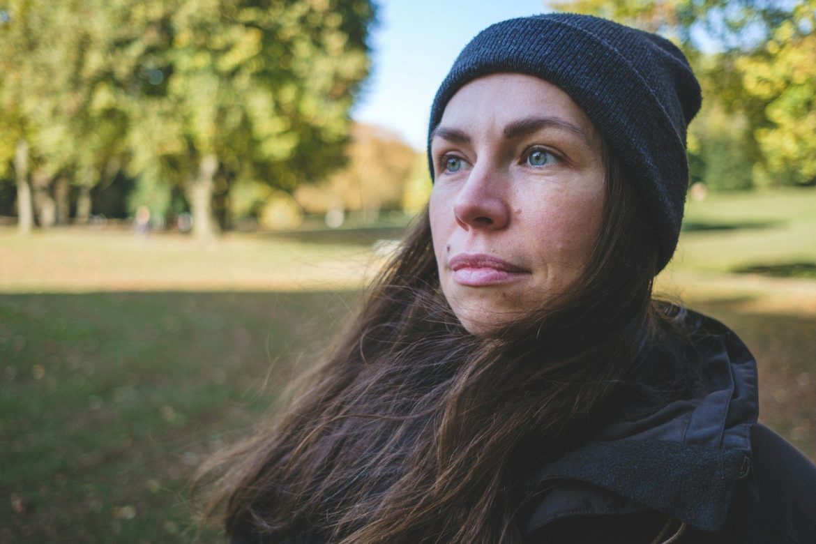 woman in black knit cap and black jacket